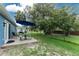 Cozy patio set in a well-maintained green backyard with shade at 4583 S Salford Blvd, North Port, FL 34287
