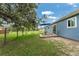 Lush backyard featuring a patio, grill, and a chain-link fence, perfect for outdoor entertaining and relaxation at 4583 S Salford Blvd, North Port, FL 34287