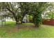 Backyard featuring trees, a shed and some green grass at 4583 S Salford Blvd, North Port, FL 34287