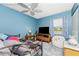 Comfortable bedroom featuring a ceiling fan, large TV, and cozy decor at 4583 S Salford Blvd, North Port, FL 34287