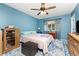 Comfortable bedroom with blue walls, ceiling fan, and hardwood floors at 4583 S Salford Blvd, North Port, FL 34287