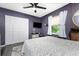 Comfortable bedroom with gray walls, closet, and ceiling fan at 4583 S Salford Blvd, North Port, FL 34287