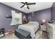 Comfortable bedroom with gray walls, window, and ceiling fan at 4583 S Salford Blvd, North Port, FL 34287