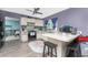 Bright kitchen featuring stainless steel appliances, an island with barstools, and a charming colorful rug at 4583 S Salford Blvd, North Port, FL 34287