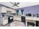 Well-lit kitchen boasts an island with stools and updated appliances, complemented by a colorful area rug at 4583 S Salford Blvd, North Port, FL 34287