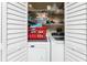 Organized laundry room with appliances, storage shelves, and a well-maintained washer and dryer at 4583 S Salford Blvd, North Port, FL 34287