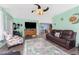 Cozy living room with ample seating, a large TV, and warm, mint-green walls at 4583 S Salford Blvd, North Port, FL 34287