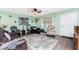 Cozy living room featuring comfortable seating, area rug, and plenty of natural light at 4583 S Salford Blvd, North Port, FL 34287