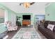 Spacious living room featuring a TV, comfortable seating, and an area rug at 4583 S Salford Blvd, North Port, FL 34287