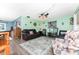 Inviting living room with ample seating, area rug, and warm, mint-green walls at 4583 S Salford Blvd, North Port, FL 34287