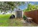 Backyard featuring a storage shed with double doors, providing ample space for outdoor equipment and tools at 4583 S Salford Blvd, North Port, FL 34287