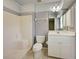 Bathroom featuring a white vanity, a shower, and a toilet at 4609 Jaslo Ave, North Port, FL 34286