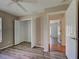 A bedroom with a closet and an open doorway, neutral walls, and wood-look laminate flooring at 4609 Jaslo Ave, North Port, FL 34286
