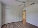 Bedroom with modern vinyl flooring, a closet and an open doorway to the bathroom at 4609 Jaslo Ave, North Port, FL 34286
