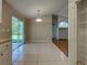 Open dining space with tile flooring, sliding glass door access, and a bright light fixture at 4609 Jaslo Ave, North Port, FL 34286