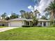 Well-maintained single-story home with a spacious lawn and attached two-car garage in a landscaped neighborhood at 4609 Jaslo Ave, North Port, FL 34286