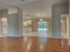 Open-concept living room and kitchen with wood floors and sliding glass doors to a patio at 4609 Jaslo Ave, North Port, FL 34286