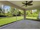 View from the covered patio, showcasing a large, grassy backyard with lush trees and plantings at 4609 Jaslo Ave, North Port, FL 34286