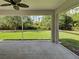 Covered patio with concrete flooring and a fan offers views of a lush, green backyard at 4609 Jaslo Ave, North Port, FL 34286