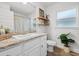 Bright bathroom with a granite-look countertop, white cabinets and stylish decor at 5436 Jessamine Ave, North Port, FL 34291