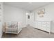 Bright and airy Bedroom with a crib, dresser, and calming neutral tones offers a peaceful retreat for a baby at 5436 Jessamine Ave, North Port, FL 34291