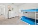 This cozy bedroom features a bunk bed, gray carpet and playful dinosaur art at 5436 Jessamine Ave, North Port, FL 34291