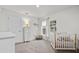 Bright, airy Bedroom with neutral colors, a crib, dresser, and ample natural light offers a comforting space at 5436 Jessamine Ave, North Port, FL 34291