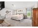 Spacious bedroom with neutral tones, large windows, and a king-size bed provides a serene and inviting atmosphere at 5436 Jessamine Ave, North Port, FL 34291