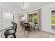 Bright breakfast nook with a round wooden table and views of the wooded back yard at 5436 Jessamine Ave, North Port, FL 34291