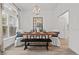 Elegant dining room with modern chandelier, seating for six, and stylish decor at 5436 Jessamine Ave, North Port, FL 34291