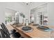 Open dining area with wood table setting, elegant decor, and stylish lighting at 5436 Jessamine Ave, North Port, FL 34291