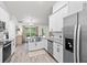Kitchen with stainless appliances and long countertop that offers views of the dining space at 5436 Jessamine Ave, North Port, FL 34291