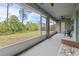 Large screened lanai with ceiling fans overlooks the green backyard at 5436 Jessamine Ave, North Port, FL 34291