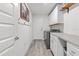 Well-organized laundry room with cabinetry, counter space, and modern appliances to makes chores a breeze at 5436 Jessamine Ave, North Port, FL 34291