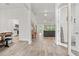 Bright, open-concept living room featuring light wood floors and abundant natural light at 5436 Jessamine Ave, North Port, FL 34291