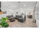Spacious living room with hardwood floors, a large sectional sofa, and a view into the kitchen at 5436 Jessamine Ave, North Port, FL 34291