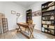 Well-lit home office featuring a wooden desk, bookshelves, and neutral decor at 5436 Jessamine Ave, North Port, FL 34291
