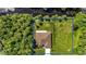 An aerial view shows a well-maintained house with a spacious lawn and a fenced backyard at 5451 Prime Ter, North Port, FL 34286