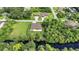 This eye-level view shows a modern home with a fenced yard and verdant landscaping at 5451 Prime Ter, North Port, FL 34286