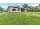 Expansive backyard featuring a lush lawn and the home's rear facade at 5451 Prime Ter, North Port, FL 34286