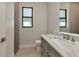 Modern bathroom with a marble countertop vanity, sleek fixtures, and natural light at 5451 Prime Ter, North Port, FL 34286