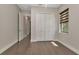 Bedroom featuring hardwood floors, a closet, and natural light from a window at 5451 Prime Ter, North Port, FL 34286