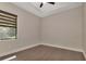 Cozy bedroom with a tray ceiling, hardwood floors, and a large window at 5451 Prime Ter, North Port, FL 34286