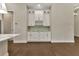 Stylish built-in bar area featuring white cabinetry, a wine rack, and elegant countertop at 5451 Prime Ter, North Port, FL 34286