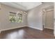 Dining room featuring hardwood floors, neutral walls, an elegant chandelier, and natural light at 5451 Prime Ter, North Port, FL 34286