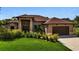 Stunning single-story home with manicured lawn and elegant landscaping, complemented by a two-car garage at 5451 Prime Ter, North Port, FL 34286