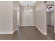 Grand foyer featuring hardwood floors, neutral walls, an elegant chandelier, and double doors at 5451 Prime Ter, North Port, FL 34286