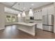 Modern kitchen with a large island, stainless steel appliances, and sleek white cabinets at 5451 Prime Ter, North Port, FL 34286