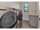Laundry room with stainless steel Samsung washer and dryer and a window view at 5451 Prime Ter, North Port, FL 34286