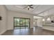Open floor plan featuring sliding glass doors to the screened patio and hardwood floors at 5451 Prime Ter, North Port, FL 34286